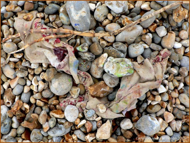 Artist's paint rags on beach pebbles
