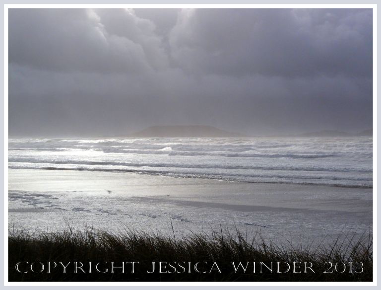 Wet, wild & windy at Rhossili (6) - The storm-tossed sea and white seafoam on the beach at Rhossili, Gower, South Wales, looking towards Worms Head.