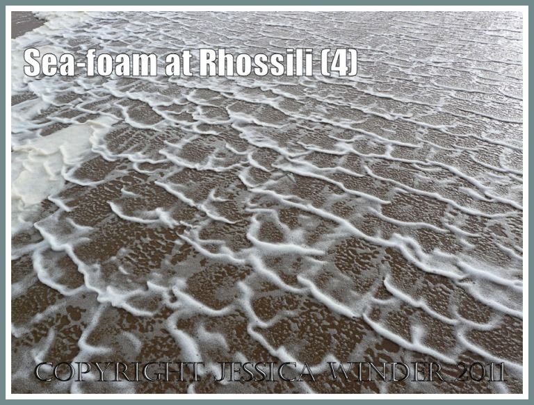 Sea-foam natural pattern: Sea-foam pattern moving across the low-tide sand at Rhossili Bay, Gower, South Wales, UK (P1440233aBlog4)
