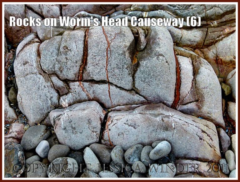 Rocks on the Worm's Head Causeway: Water-worn Carboniferous limestone grey rock strata with cracks and fissures filled with red on the Worm's Head Causeway, Rhossili, Gower, South Wales, UK (6)