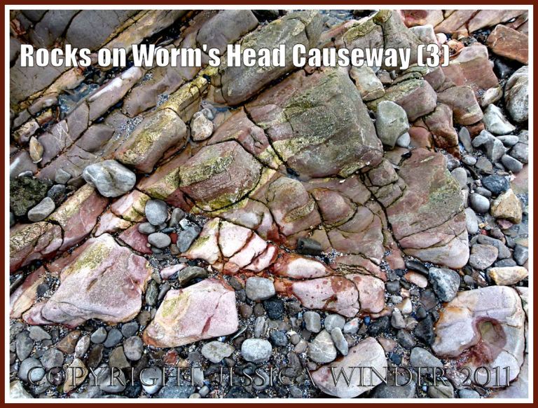 Rocks at Worm's Head Causeway: Water-worn Carboniferous limestone pink and grey rock strata with cracks and fissures filled with red on the Worm's Head Causeway, Rhossili, Gower, South Wales, UK (3)