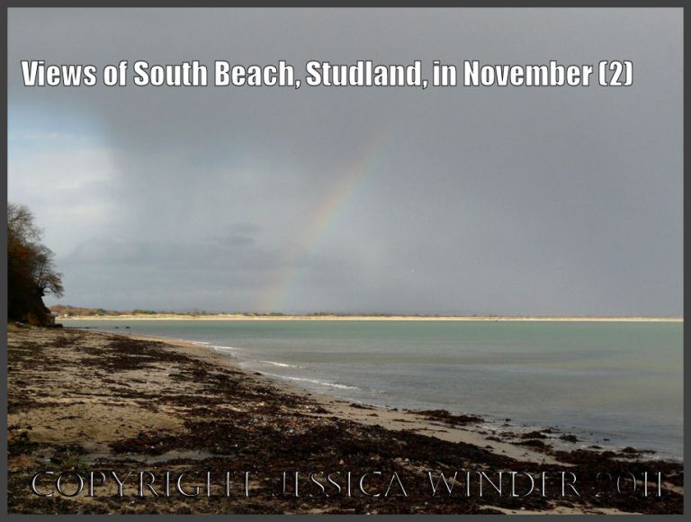 Studland Bay view: View from South Beach of a rainbow's end illuminating the long sandy strip of Knoll Beach, Studland Bay, Dorset, UK - part of the Jurassic Coast 27th November 2009 (2)