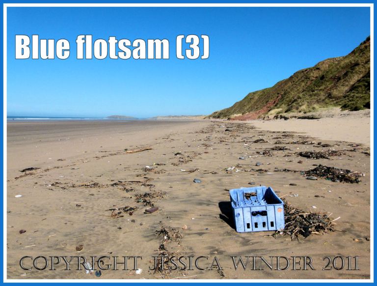 P1000682aBlog3 Blue plastic crate washed ashore as flotsam on the sandy beach at Rhossili Bay, Gower, South Wales, UK (3) Blue flotsam: Blue plastic crate washed ashore as flotsam on the sandy beach at Rhossili Bay, Gower, South Wales, UK (3)