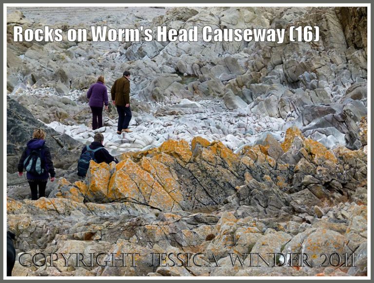 P1010184aBlog16 Upper shore sharp rocks and lower shore smooth rocks on Worms Head Causeway, Gower, South Wales, UK - similar view to image (15) but with people to give a sense of scale (16) Sharp rocks and smooth rocks on the beach: Upper shore sharp rocks and lower shore smooth rocks on Worms Head Causeway, Gower, South Wales, UK - similar view to image (15) but with people to give a sense of scale (16)