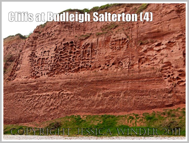 Red cliff rock textures: Triassic red rocks in the cliff at Budleigh Salterton, Devon, U.K. on the Jurassic Coast World Heritage Site, showing the difference in rock surface texture between the coarse red Otter Sandstone above and the Bunter Sandstone Pebble Beds below (4)