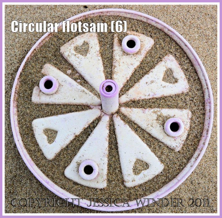 Circular flotsam: Pink plastic toy with heart shapes on the sandy strandline at Whiteford, Gower, West Glamorgan (6)