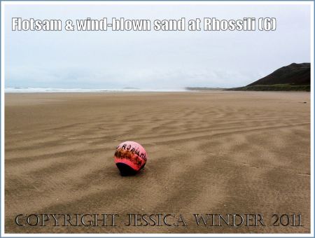 Buoy on Rhossili Beach: Red and black ship's buoy washed ashore at Rhossili Bay, Gower, South wales, UK (6)