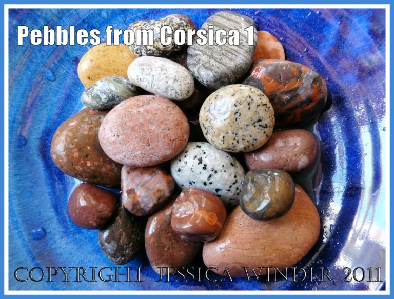 Pebbles of many colours and patterns from Corsica arranged in a blue bowl (1)