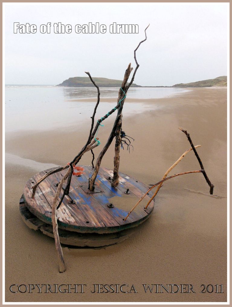 Cable drum on the beach at Rhossili Bay, Gower, West Glamorgan, decorated with driftwood and flotsam, 9th April 2009.