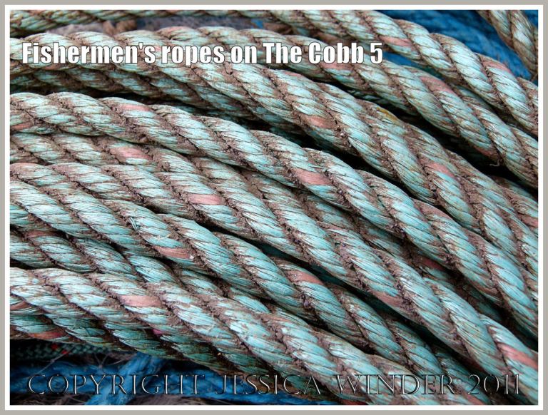 Neatly coiled dirty old ropes from a fishing boat on the quay of the Cobb at Lyme Regis, Dorset, UK (5)
