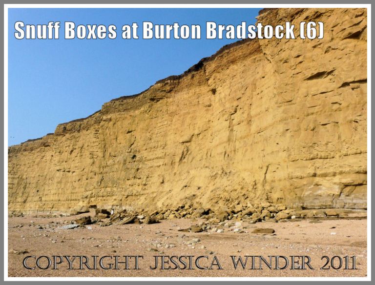 Fallen rocks at the base of the cliff at Burton Bradstock, Dorset, UK - part of the Jurassic Coast. The small figure by the boulders gives an idea of scale (6)