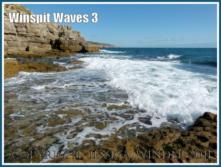 Waves breaking on the rock ledge at Winspit, Dorset, UK, on the Jurassic Coast