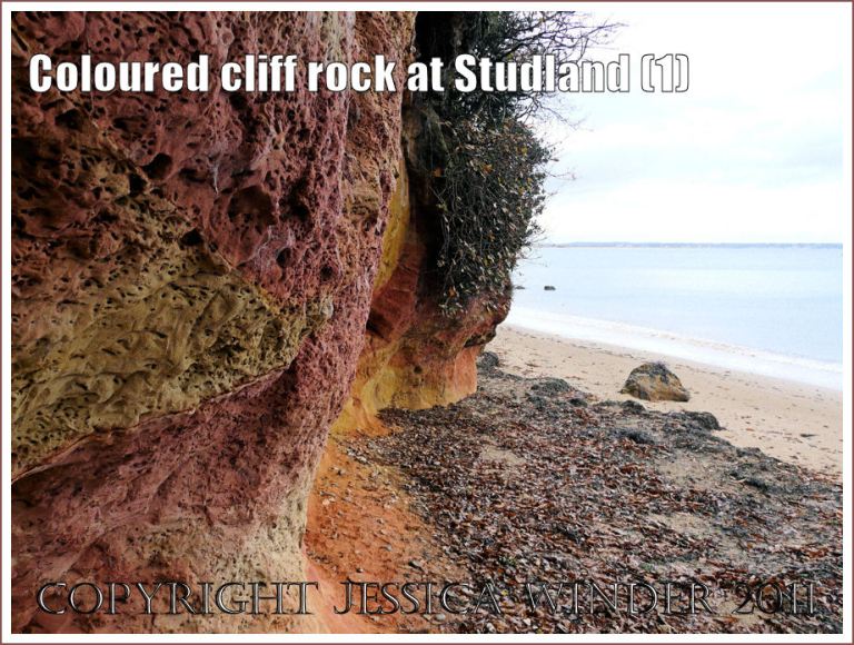 Red and orange coloured cliff rock on the seashore at Studland Bay, Dorset, UK, on the Jurassic Coast (1)