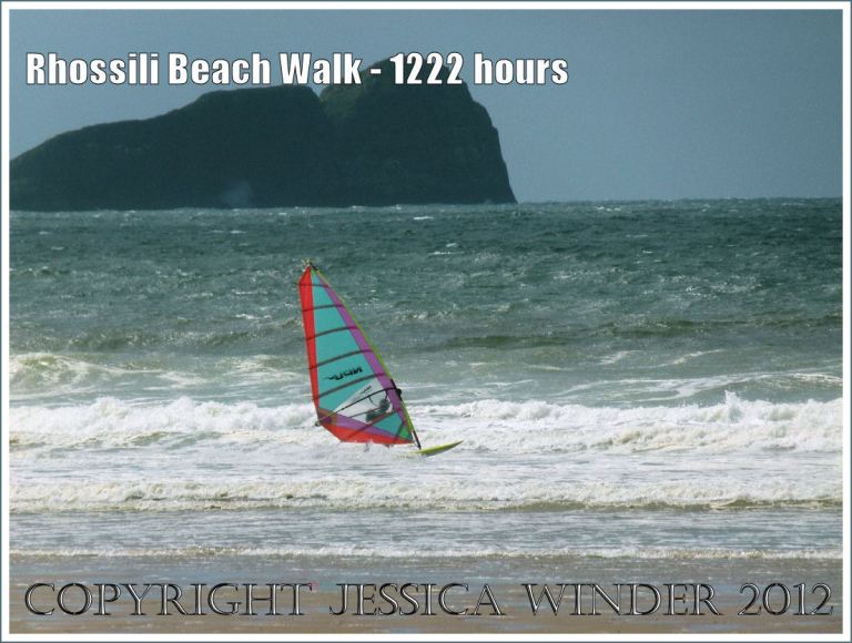 Rhossili Beach Walk - 1222 hours. Winder surfer at Rhossili Bay with Worms Head in background, Gower, South Wales, 22nd August 2012.