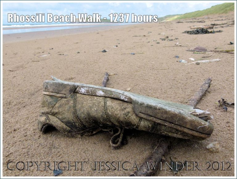 Rhossili Beach Walk - 1237 hours. Trainer shoe flotsam on the sandy strandline of Rhossili Beach, Gower, South Wales, 22nd August 2012.