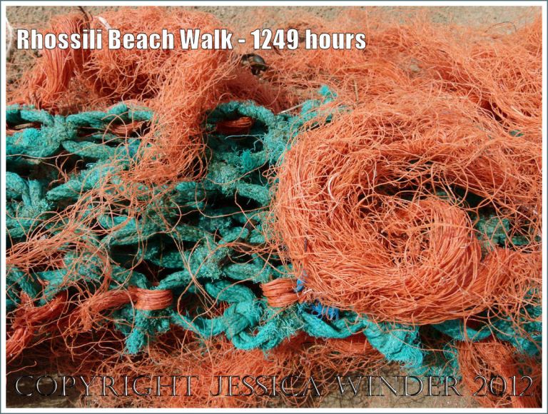 Rhossili Beach Walk - 1249 hours. Close-up detail of bright orange and green fishing net washed ashore as flotsam on Rhossili Beach, Gower, South wales, 22nd August 2012.