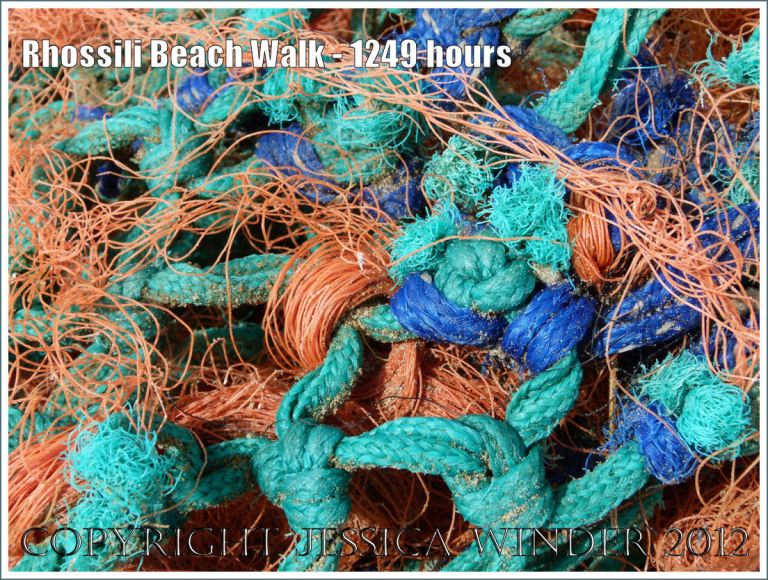 Rhossili Beach Walk - 1249 hours. Close-up detail of orange, blue, and green fishing net washed ashore as flotsam at Rhossili Bay, Gower, South Wales, 22nd August 2012.