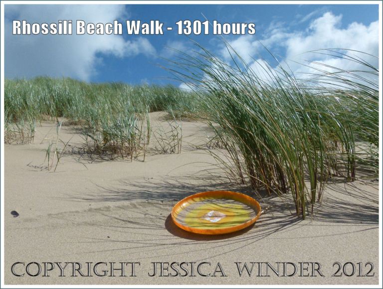 Rhossili Beach Walk - 1301 hours. Orange plastic Frisbee toy lost among the sand dunes and marram grass at Rhossili Bay, Gower, South Wales, 22nd August 2012.