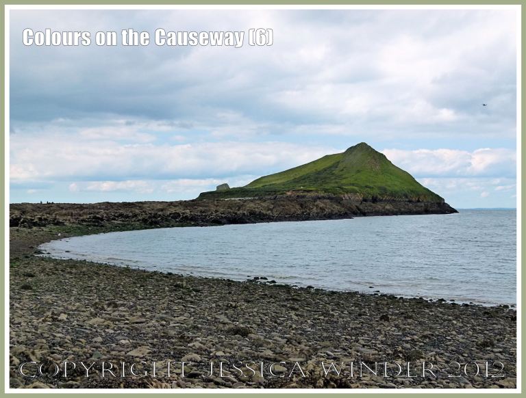 Colours on the Causeway (6) - View of Worms Head on the tip of the Gower Peninsula from mid-way along the rocky causeway at low tide - seeming uniformly dark and grey at first but in close-up providing bright patches of colour from natural features of the limestone and also the seaweeds and seashore creatures. P1240233aBlog6