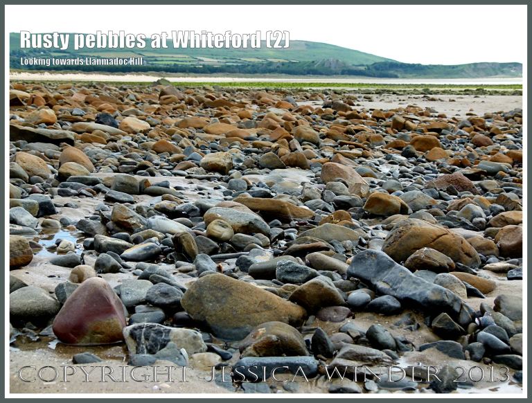 Rusty Pebbles at Whiteford (2) - View looking across to Llanmadoc Hill showing pebbles on the beach at Whiteford Sands, Gower, South Wales, some of which are covered with a rusty deposit thought to derive from the break up of an iron-pan associated with a Holocene peat layer.