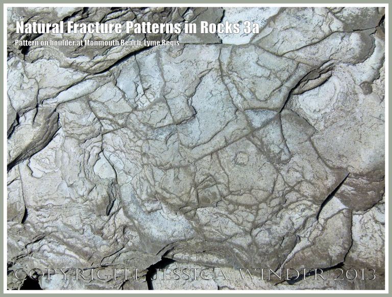 Natural Fracture Patterns in Rocks 3a - Close up photograph of natural patterns of cracks in a boulder on the shore at Monmouth Beach, Lyme Regis, Dorset, UK on the Jurassic Coast.