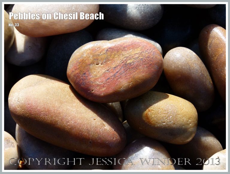 Orange and red pebbles on the beach