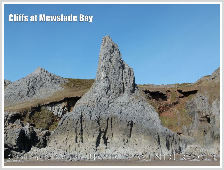 Limestone cliff peak with raised beach behind it.
