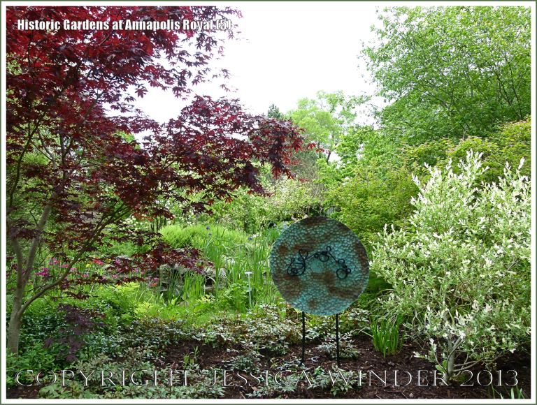 View of the Historic Gardens, Annapolis Royal, Nova Scotia, Canada with sculpture "Copper Bloom" by Catherine E. Reilly.