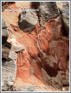Red Triassic rock remnant with calcite crystal in faulted Carboniferous limestone.