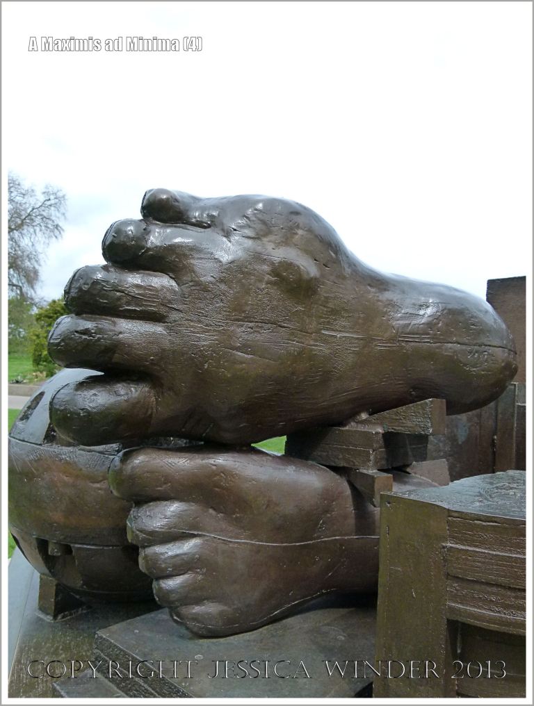 Feet on the sculpture entitled "A Maximis Ad Minima" by Sir Eduardo Paolozzi (1998)