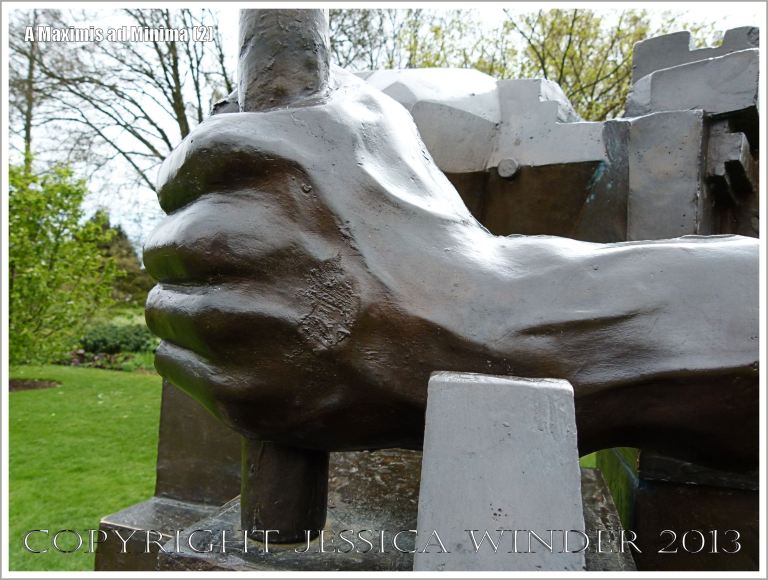 A hand on the sculpture entitled "A Maximis Ad Minima" by Sir Eduardo Paolozzi (1998)
