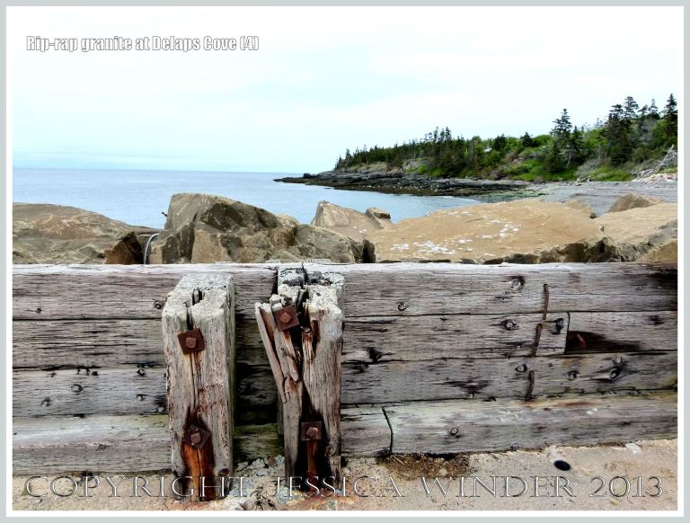 View of Delaps Cove showing sea defence rip-rap (mainly granite) rock boulders