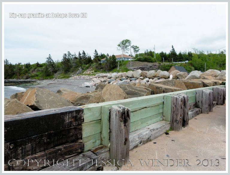 View of Delaps Cove showing sea defence rip-rap (mainly granite) rock boulders