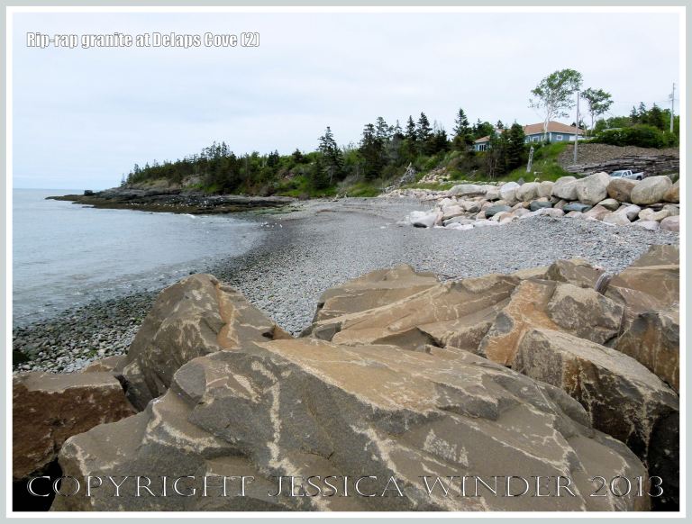 View of Delaps Cove showing sea defence rip-rap (mainly granite) rock boulders