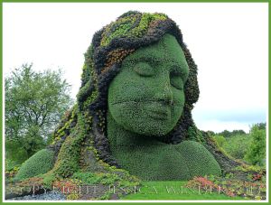 Mosaiculture tableau of sculptures made with living plants entitled "Mother Earth"