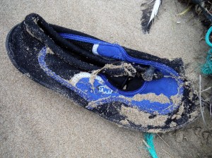 Lost beach shoe in the sand