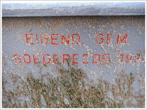 Red writing on grey plastic flotsam crate.