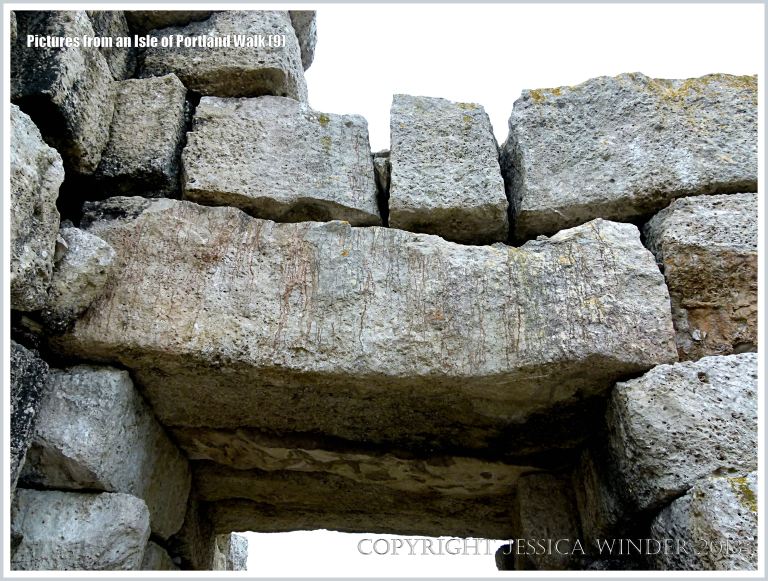 Arch of stone blocks over the coast path on the western edge of the Isle of Portland