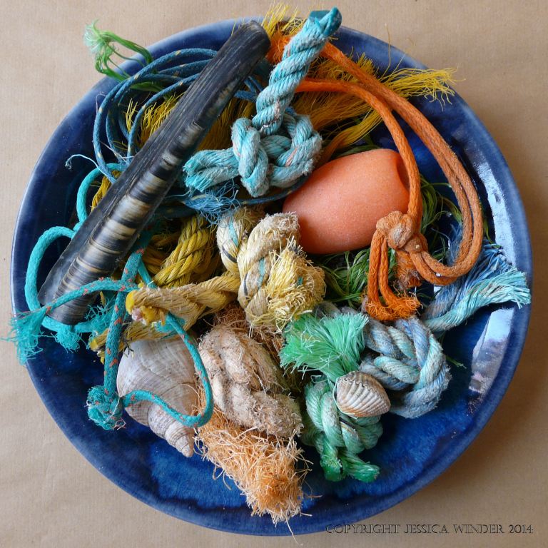An arrangement of flotsam rope and string knots with shells