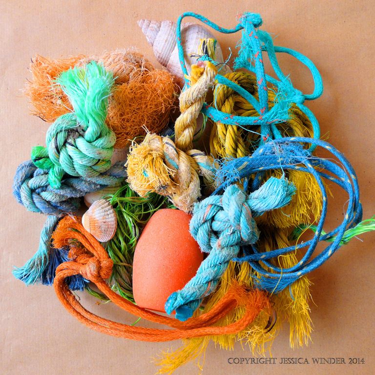 An arrangement of flotsam rope and string knots with a fishing float