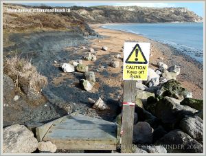 Wooden steps, smashed by storms, leading down to the east half of Ringstead Bay