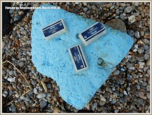 Flotsam tubs of cheese washed ashore at Ringstead Bay
