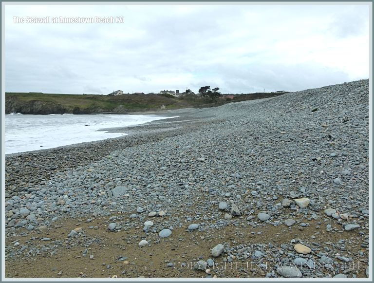The pebbles on the seashore at Annestown, banked up against a sea wall