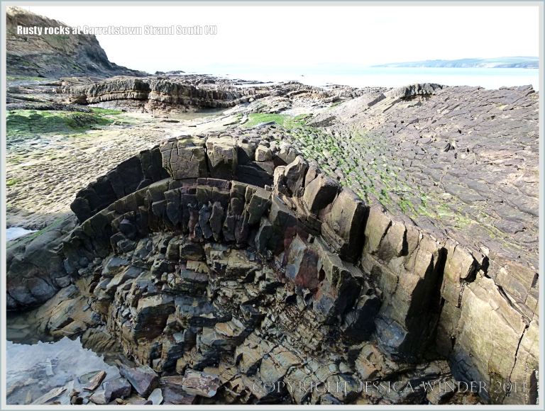 Gently folded strata with rocks coloured by iron from the Carboniferous Cork Group