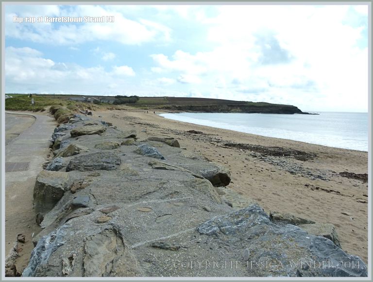 Rip-rap boulders at the top of a sandy beach