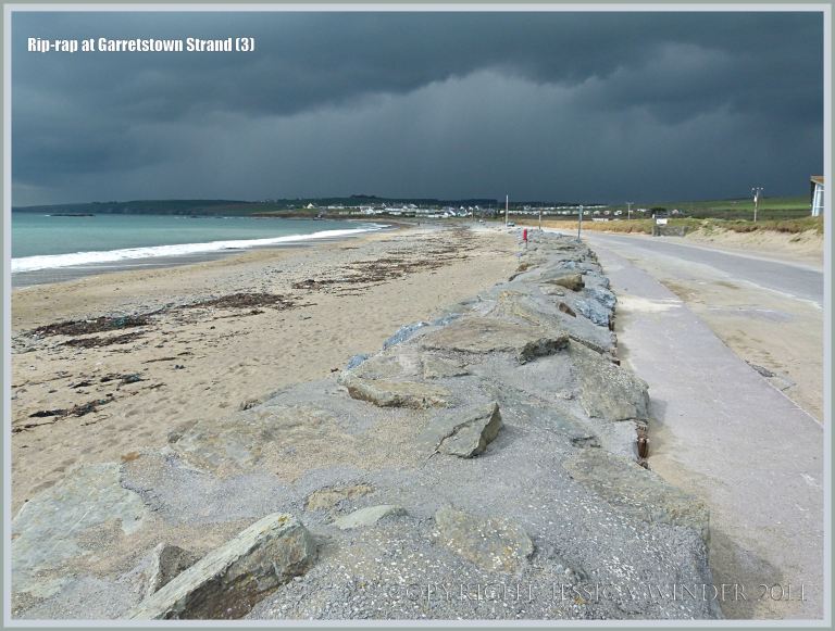Rip-rap boulders at the top of a sandy beach