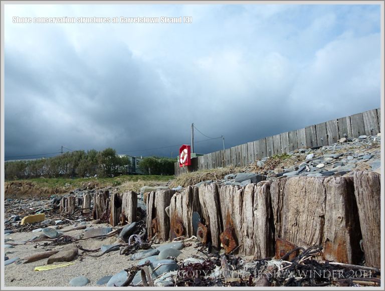 Old and new wooden revetments on a sandy beach