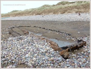 Shipwrecked wooden boat on the beach
