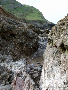 View looking through the narrow rock gully to Mewslade beach