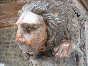 Lion carved in stone as a small part of a larger commemorative piece